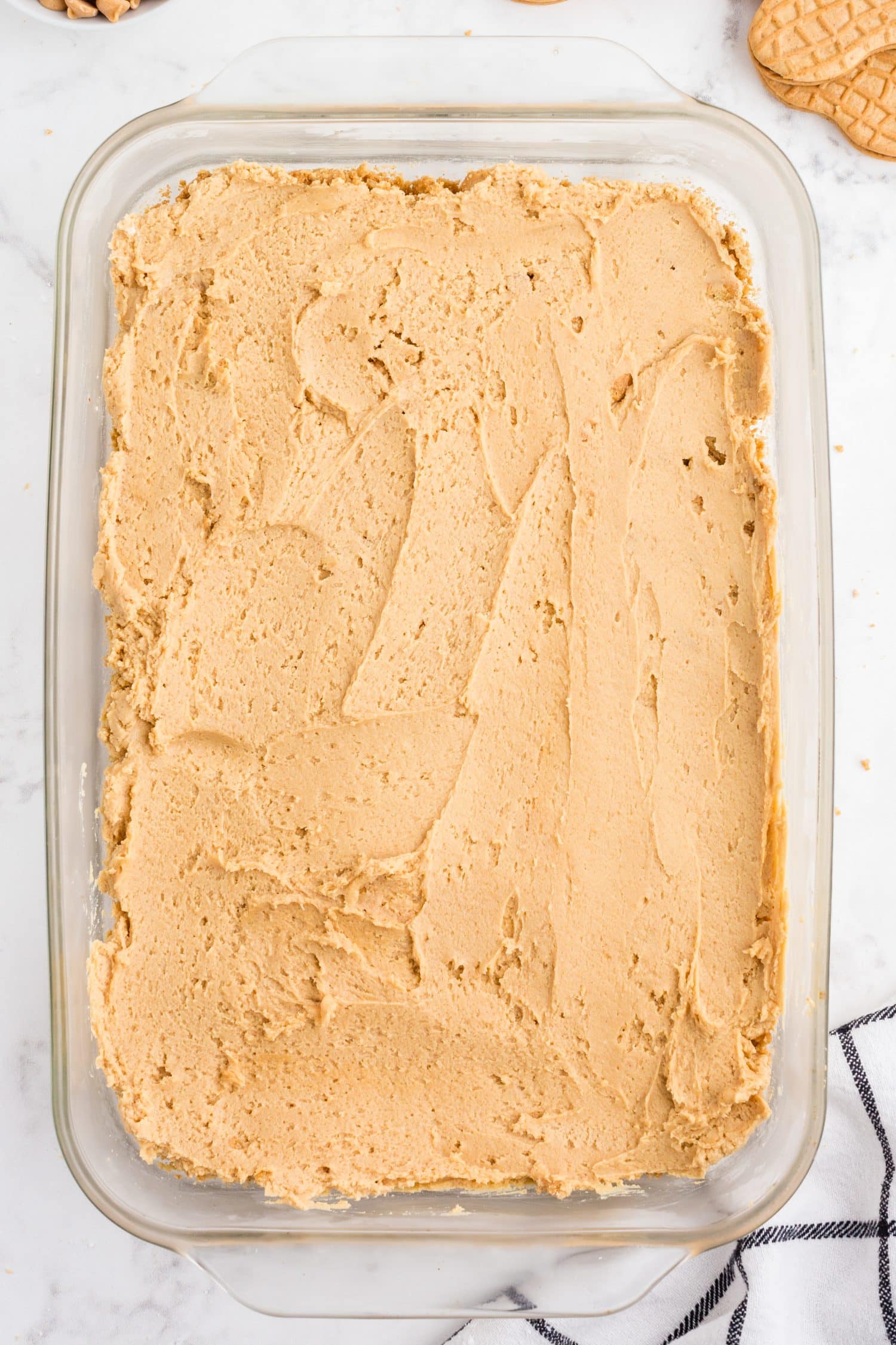 Baking dish with peanut butter cream cheese layer over the Nutter Butter dessert base.