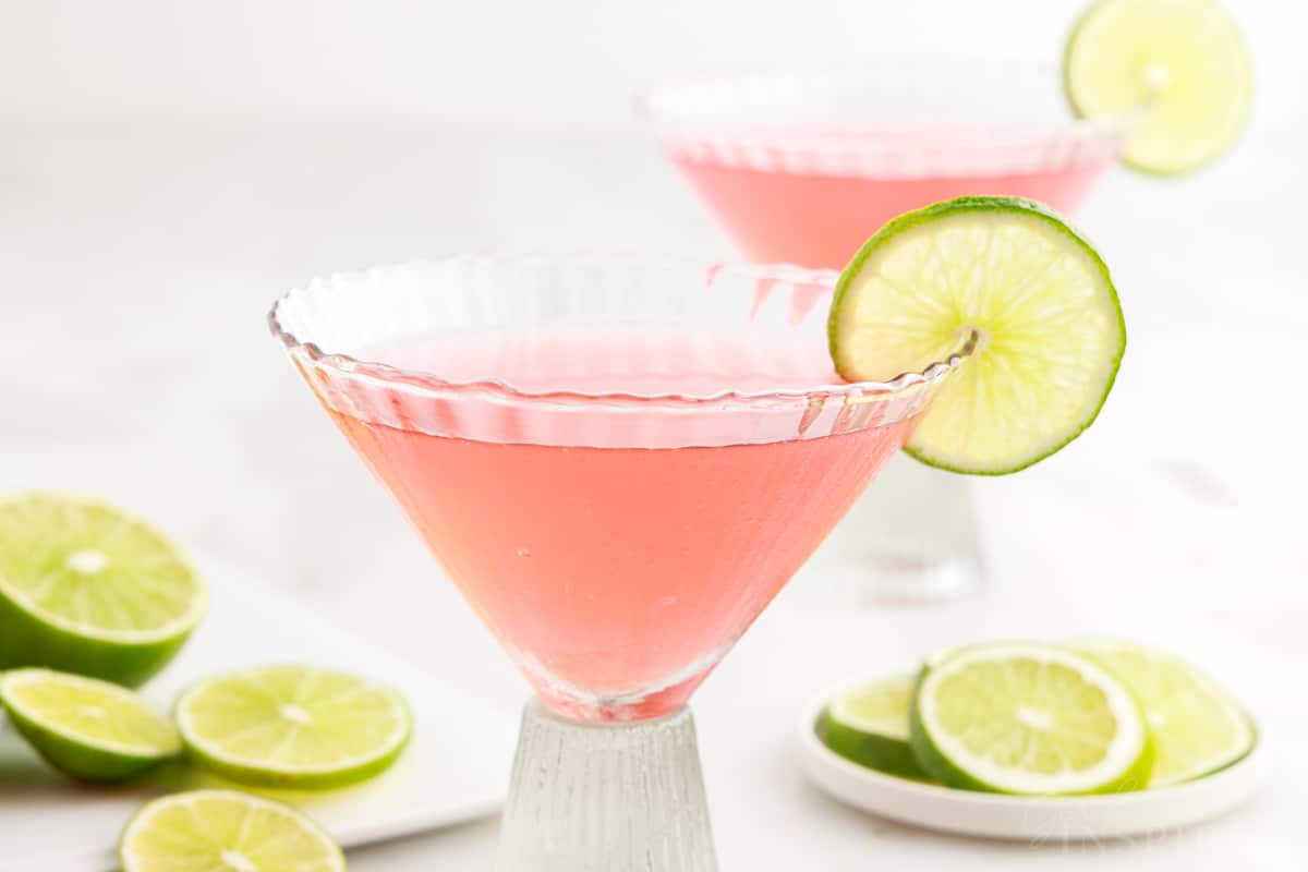Pink Flamingo Drink in two glasses garnished with limes.