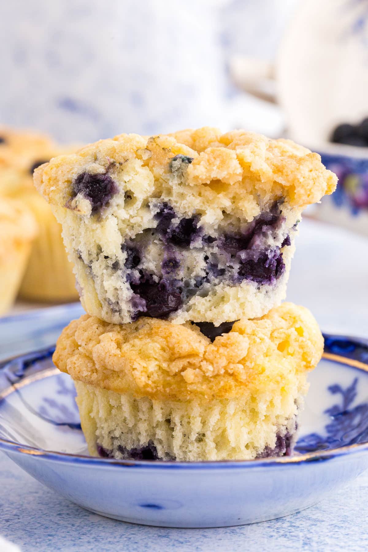 Two stacked Sourdough Blueberry Muffins on a small dish.