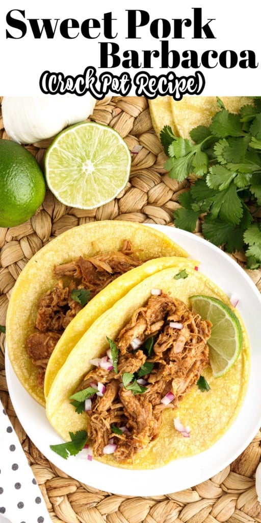 Overhead view of two Pork Barbacoa tacos on a plate next to limes and cilantro.
