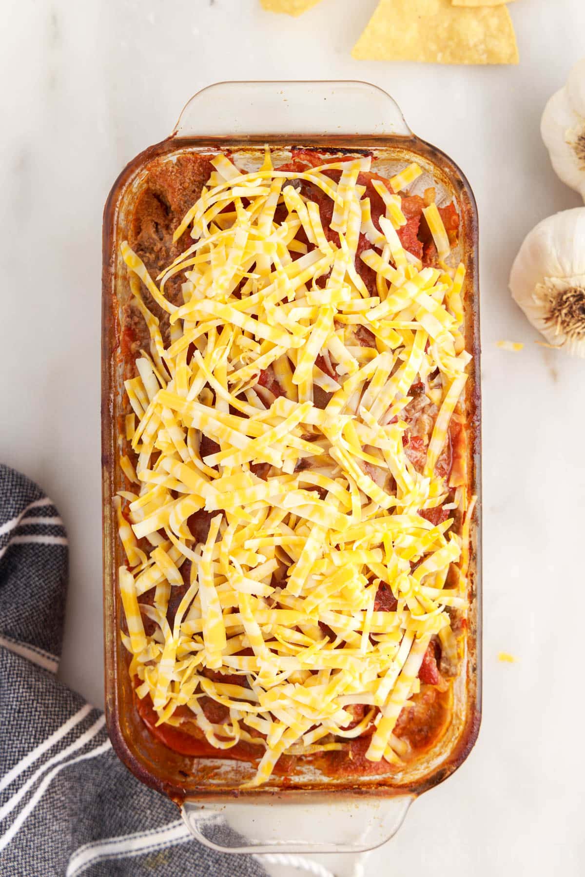 Grated cheese added to the top of the taco meatloaf.