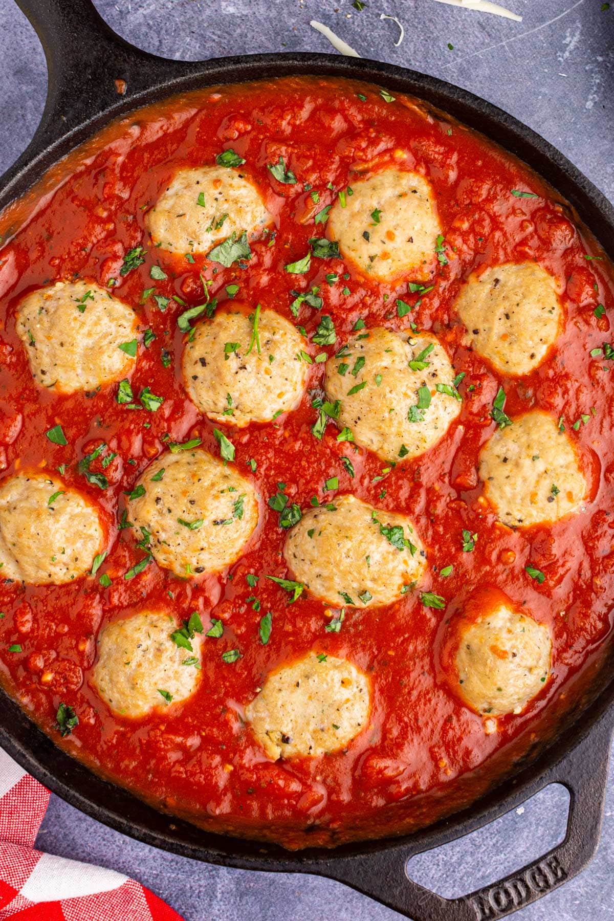 Overhead view of turkey meatballs in sauce in a skillet.