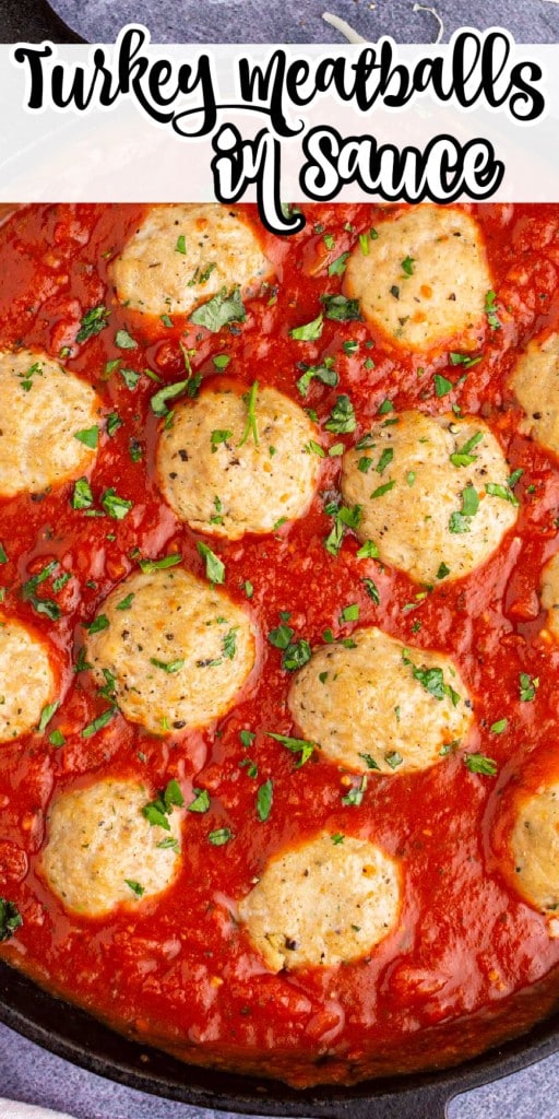 close up of turkey meatballs in sauce in a skillet.