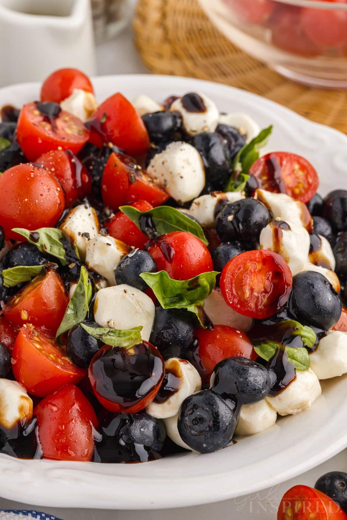 Blueberry Caprese Salad on a white dish.