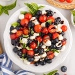 Blueberry Caprese Salad, overhead view on a white plate.