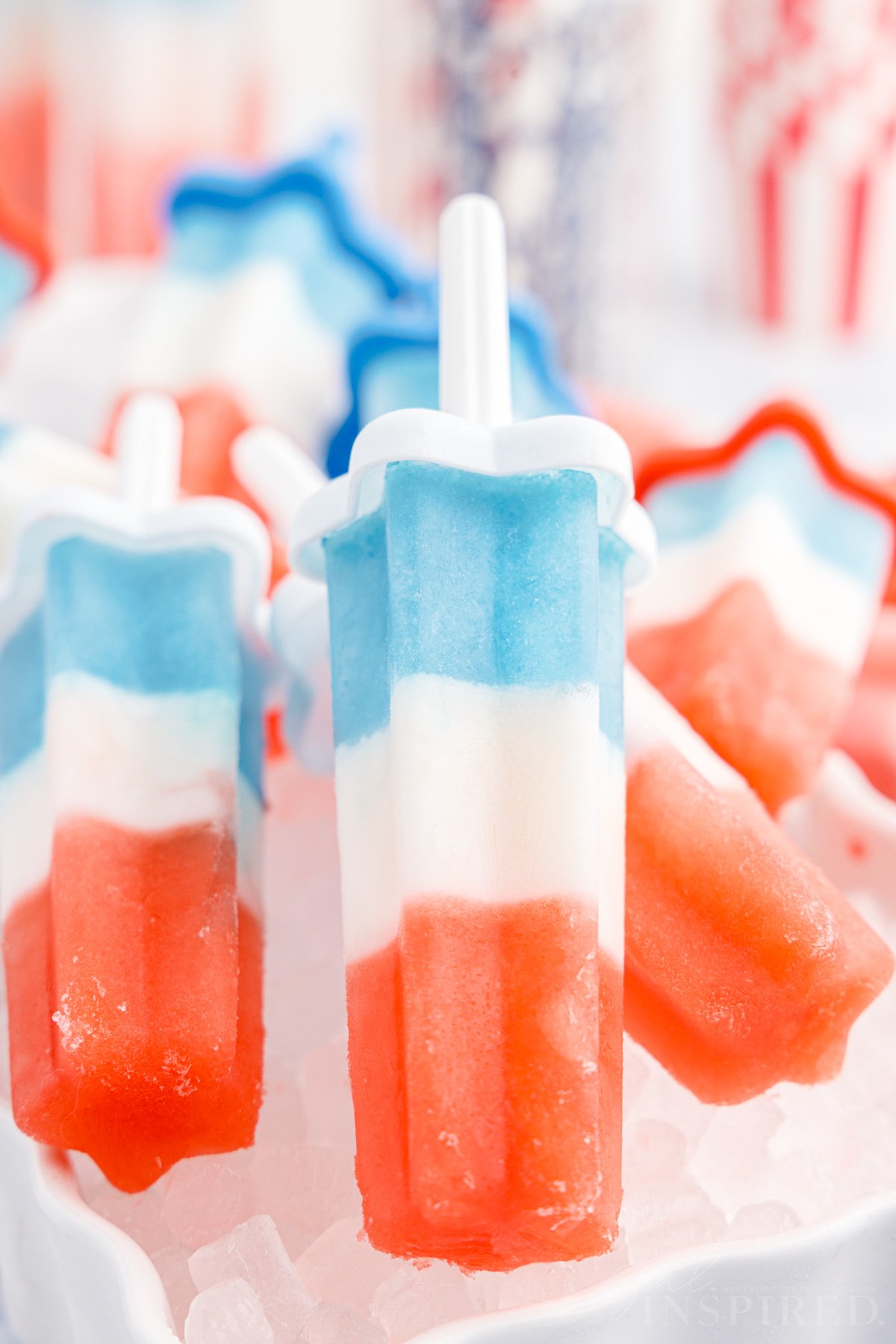 Bomb Pops stacked on each other on ice.