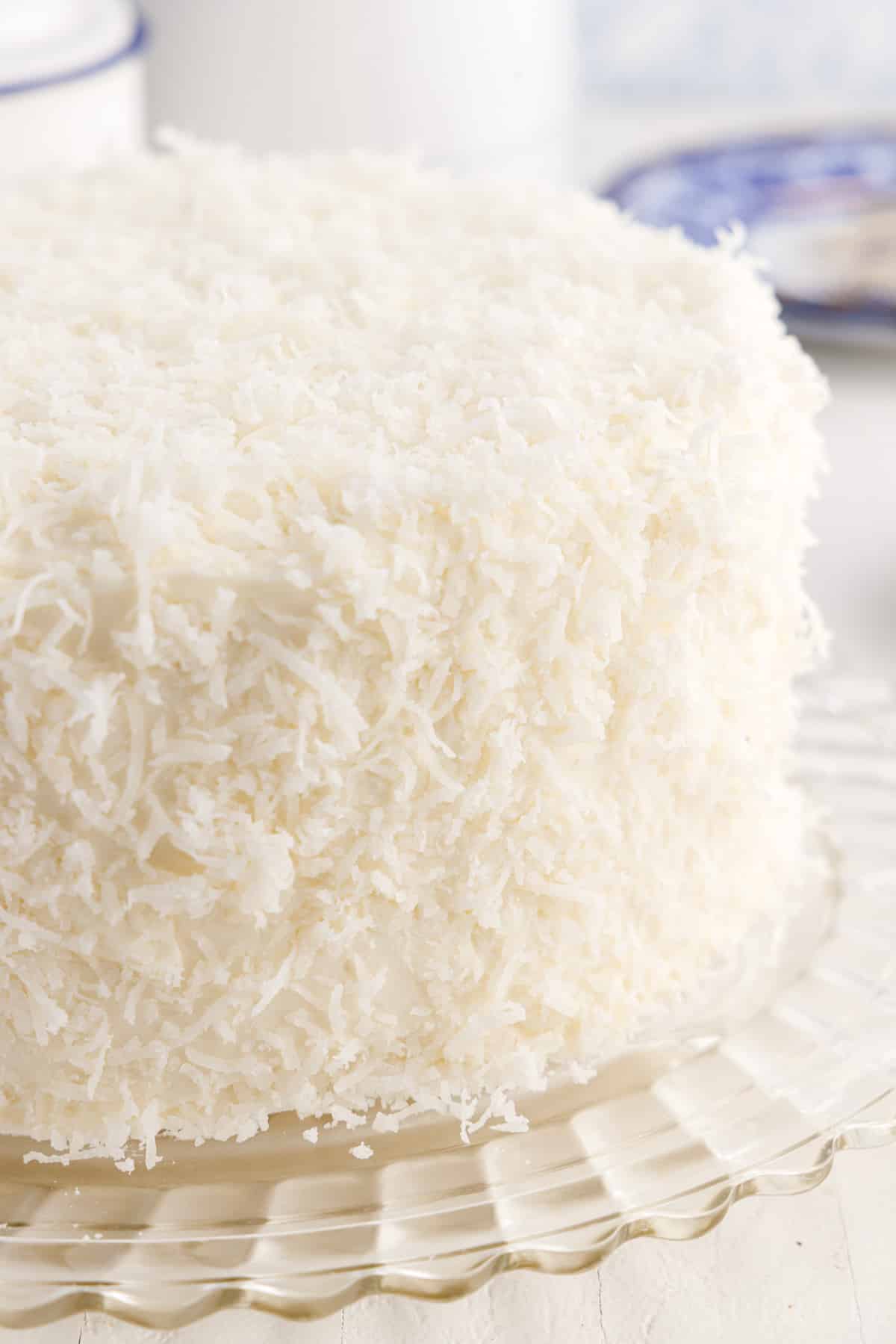 Front right view of Coconut Cream Cake on a platter.