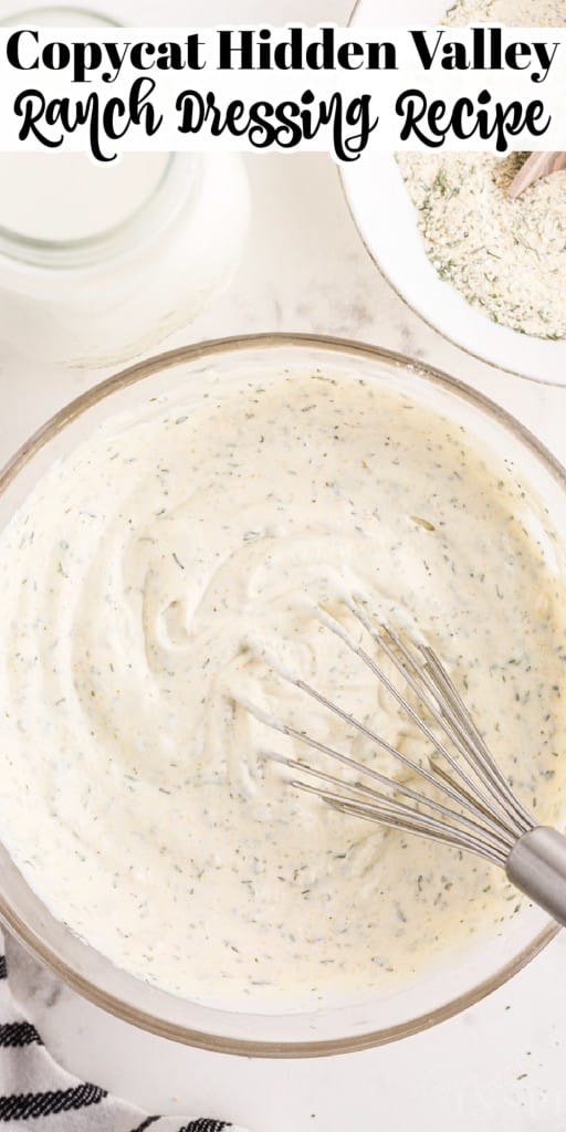 A bowl of Hidden Valley Ranch Dressing Recipe with a whisk inserted next to ranch seasoning and a milk bottle.