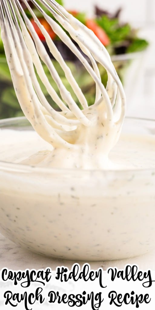 Front close up of a whisk lifted out of Hidden Valley Ranch Dressing covered in dressing.