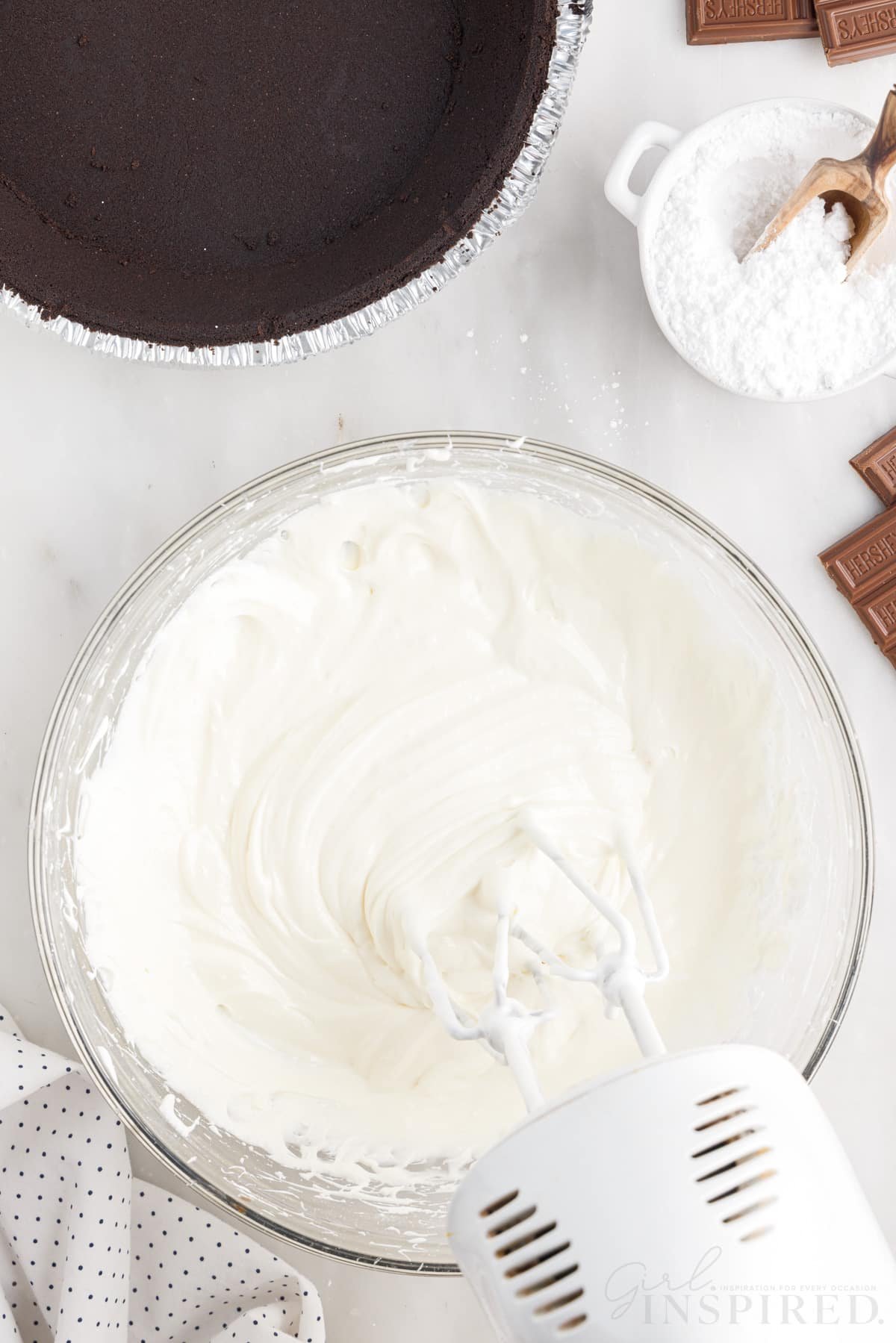 Cream cheese mixture mixed in a bowl with a hand mixer.