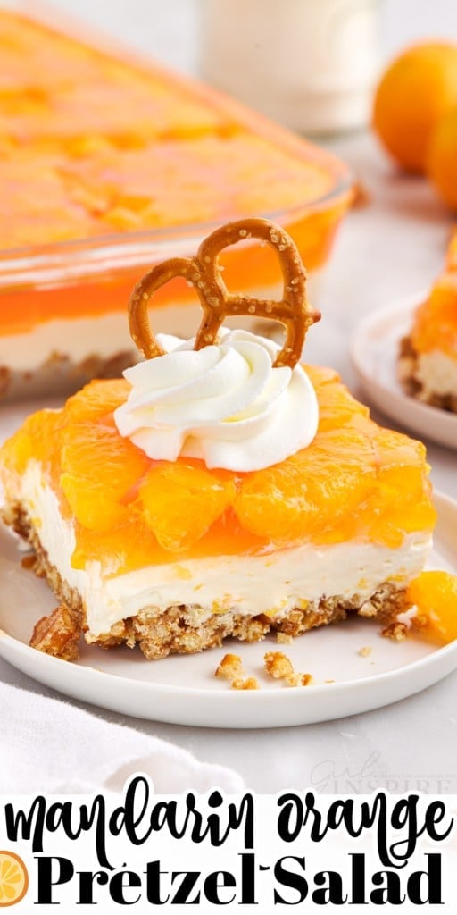 Orange Pretzel Salad on a small dish with whipped topping and a pretzel on top.