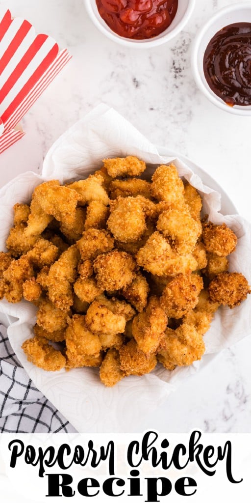Overhead view of popcorn chicken with bowls of dipping sauce on white marble counter top