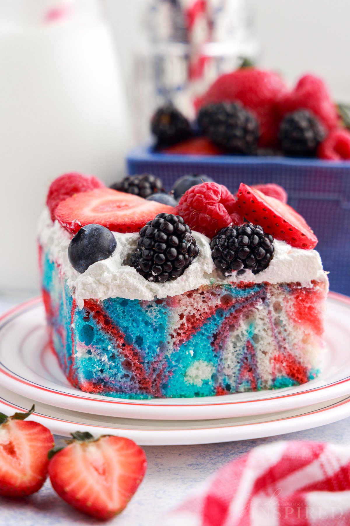 A small dish with a slice of Red White and Blue Marble Cake on it.