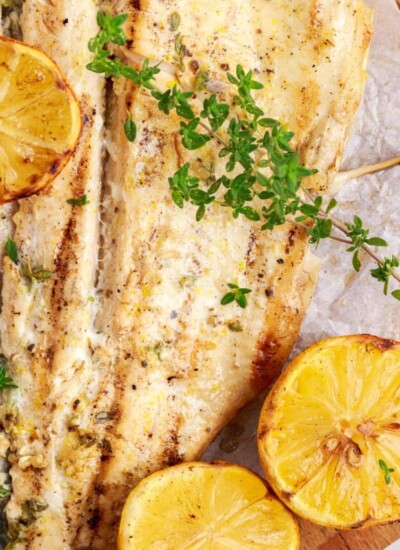 Close up overhead view of Grilled Trout in foil with lemon slices.