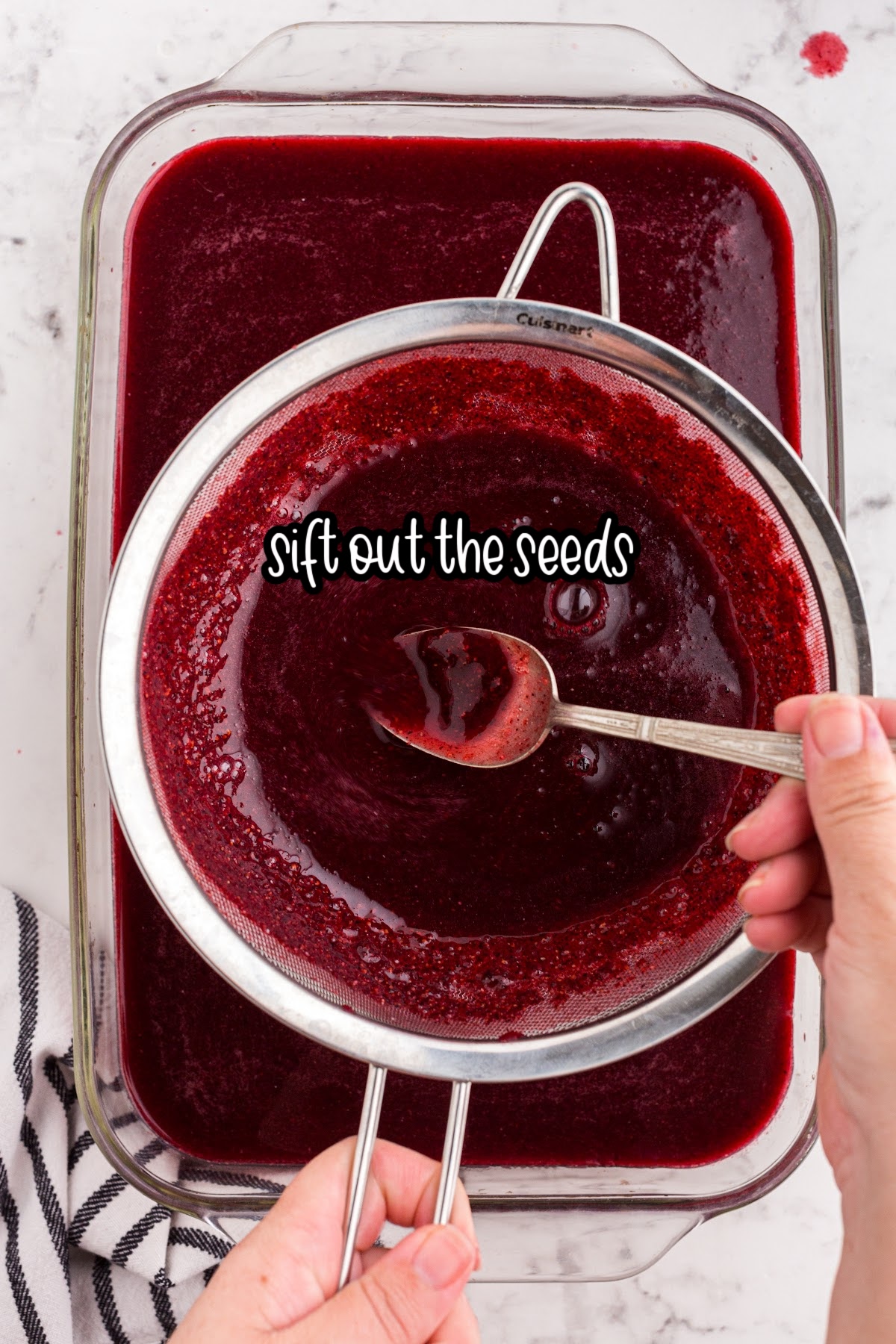 Seeds being sifted from the berry mixture with text overlay.