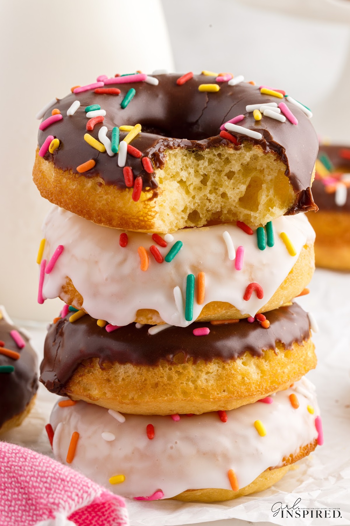 Front close up of Cake Mix Donuts with a bite taken from the top one.