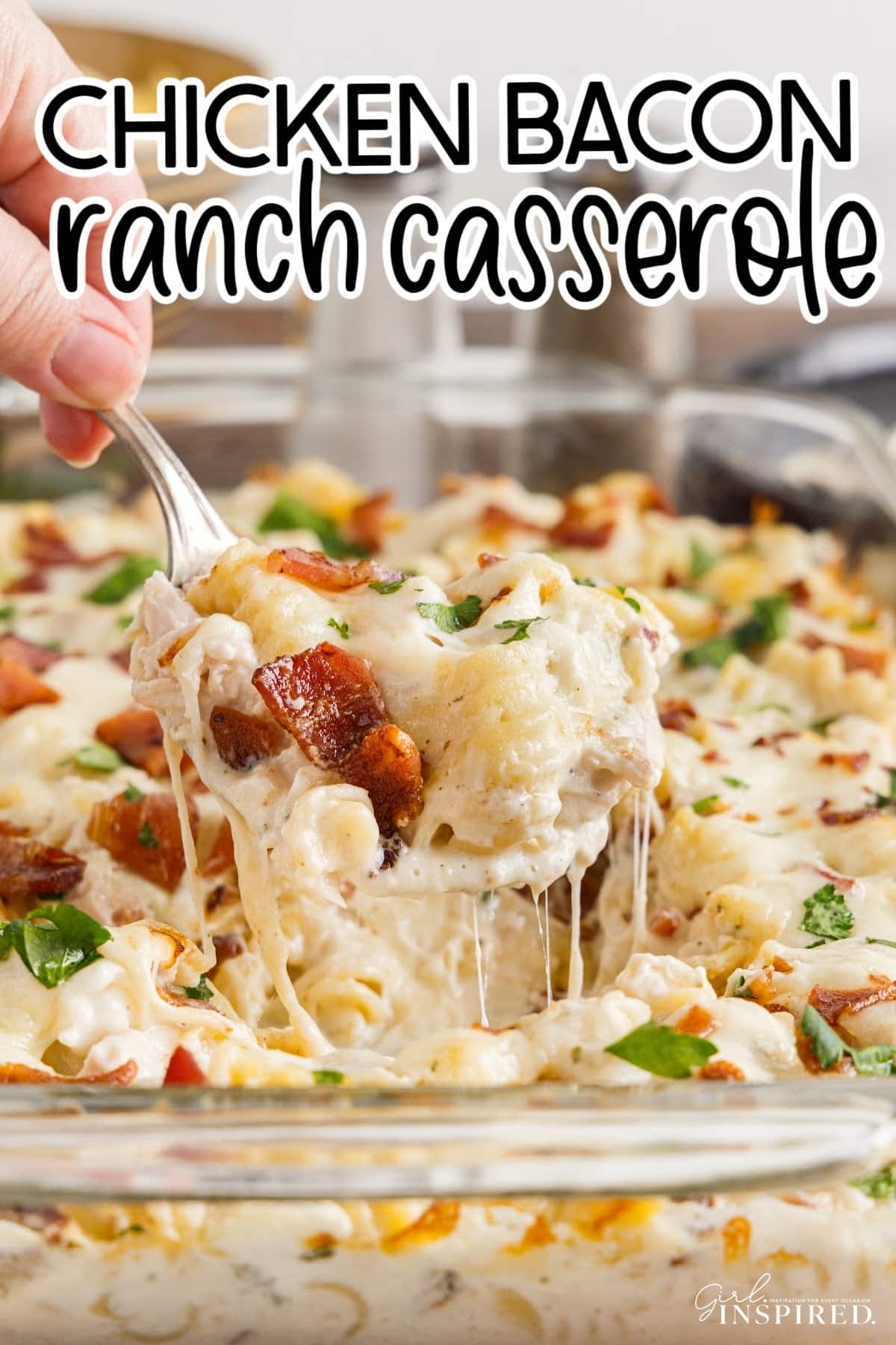 Front view of Chicken Bacon Ranch Casserole in a 9x13 and a spoon lifted out with text overlay.