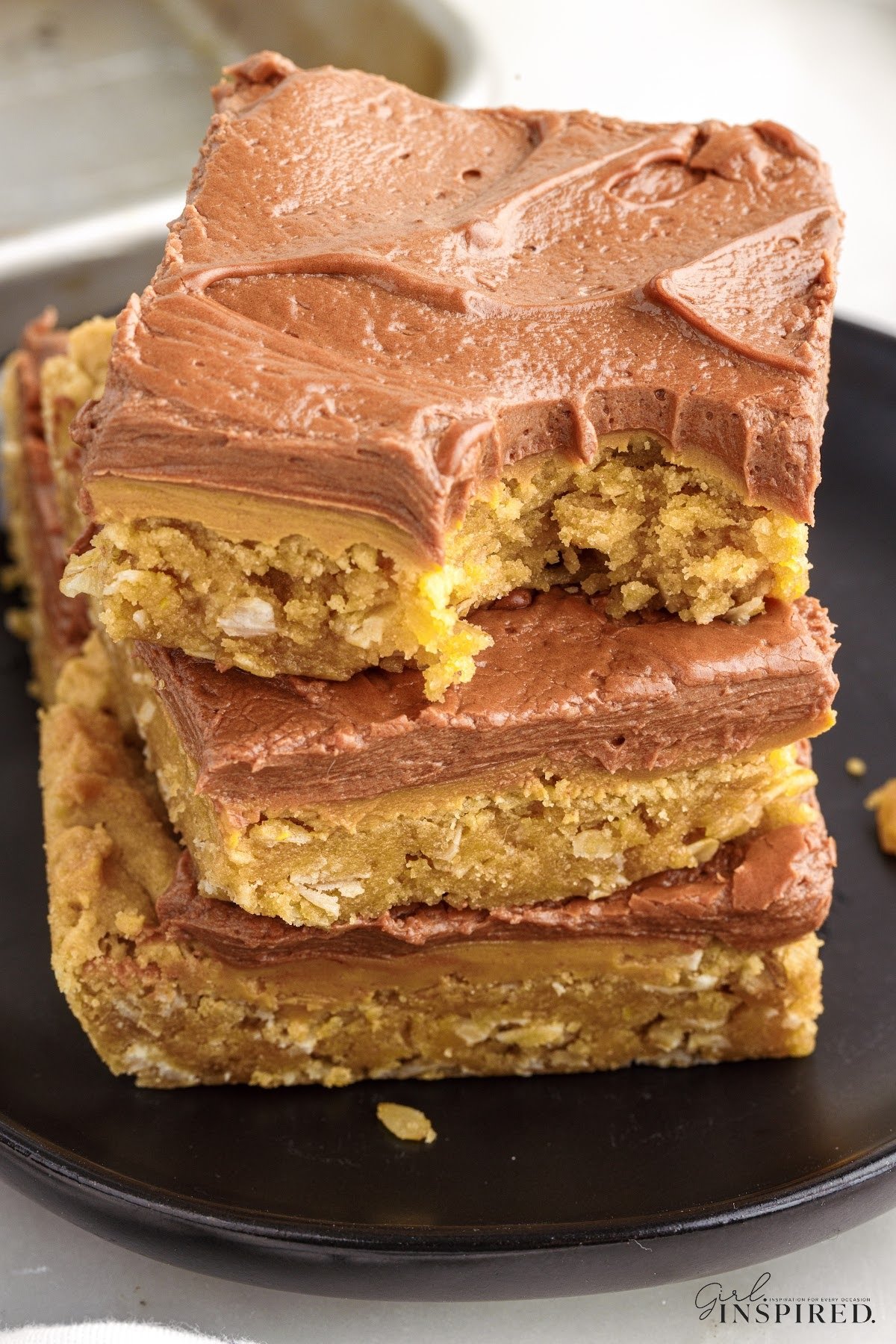 A stack of Lunch Lady Peanut Butter Bars with a bite taken from the top one.