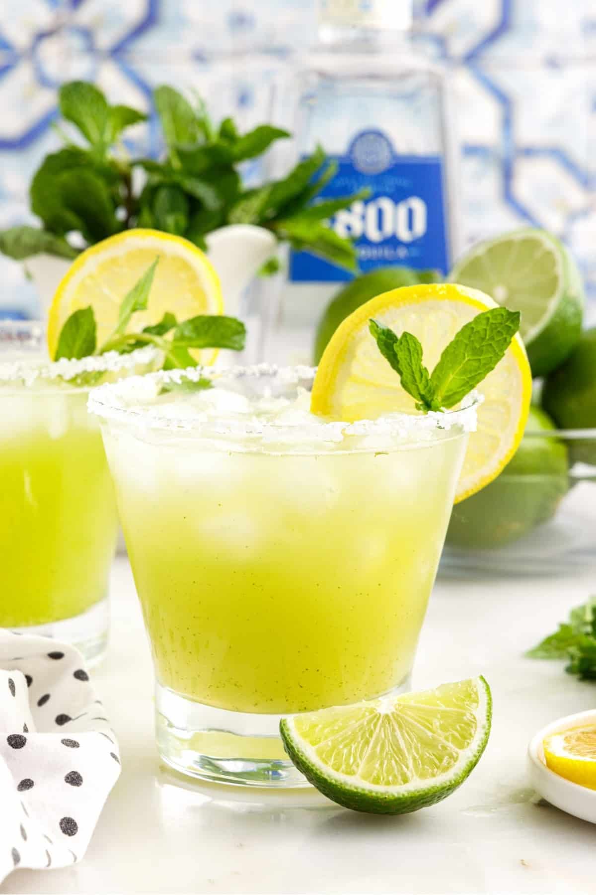 Mint Margaritas garnished with mint, lemons, and limes.