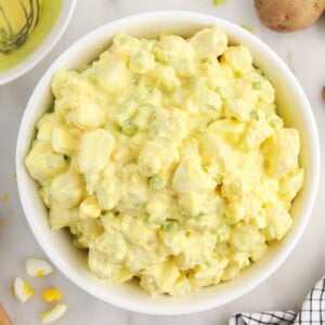 An overhead view of Amish Potato Salad in a white bowl.