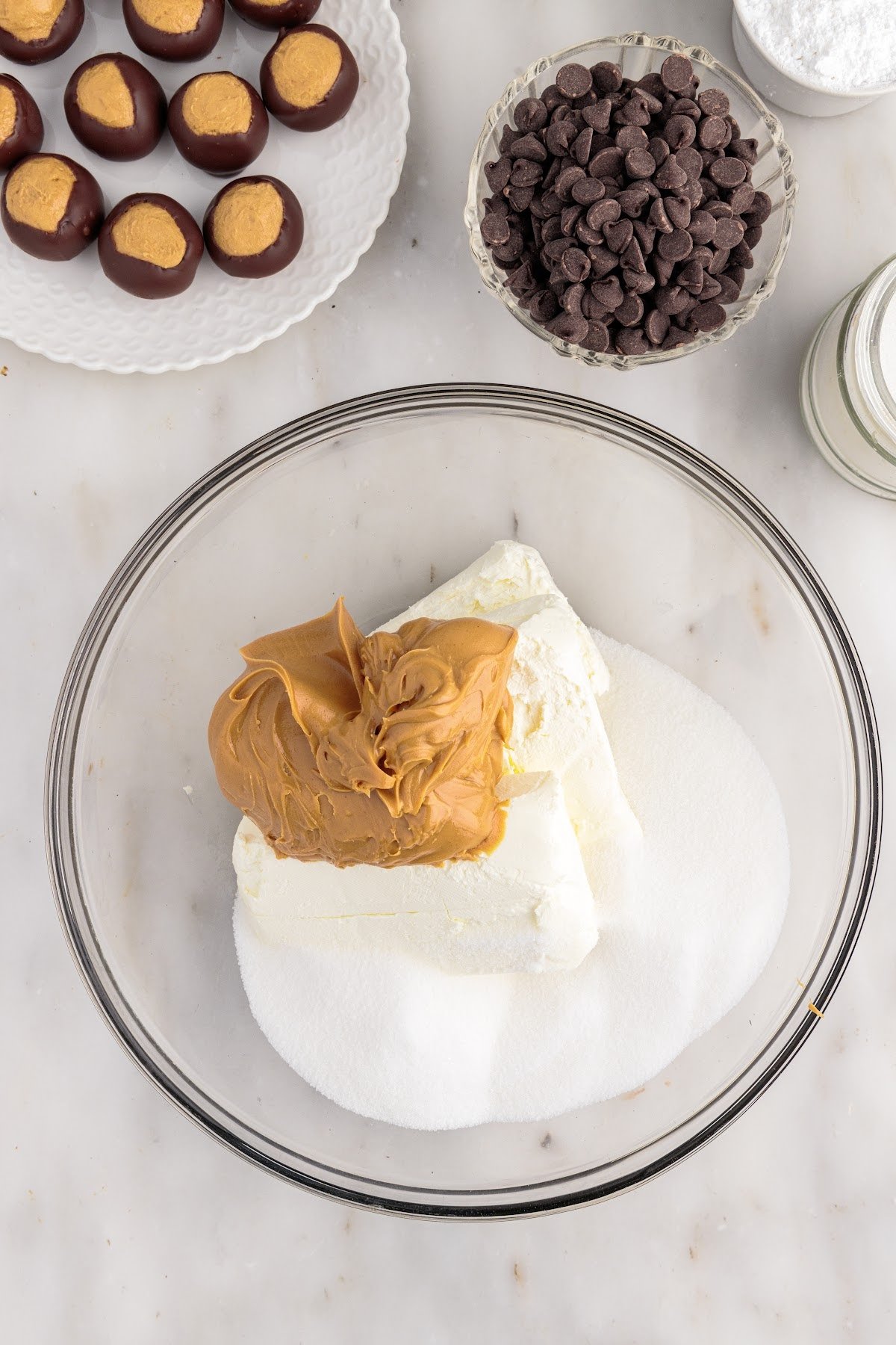 Sugar, cream cheese and peanut butter in a mixing bowl.
