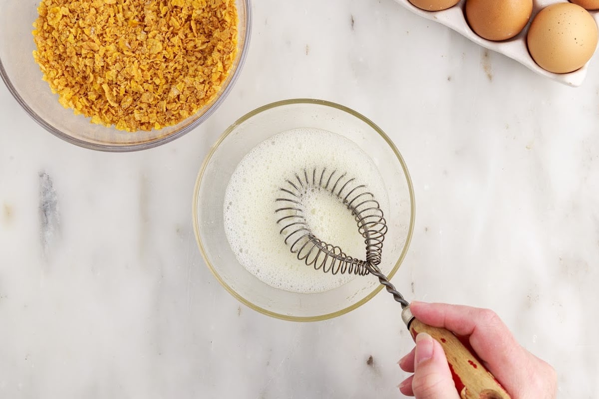 Whisking egg whites in a glass bowl.