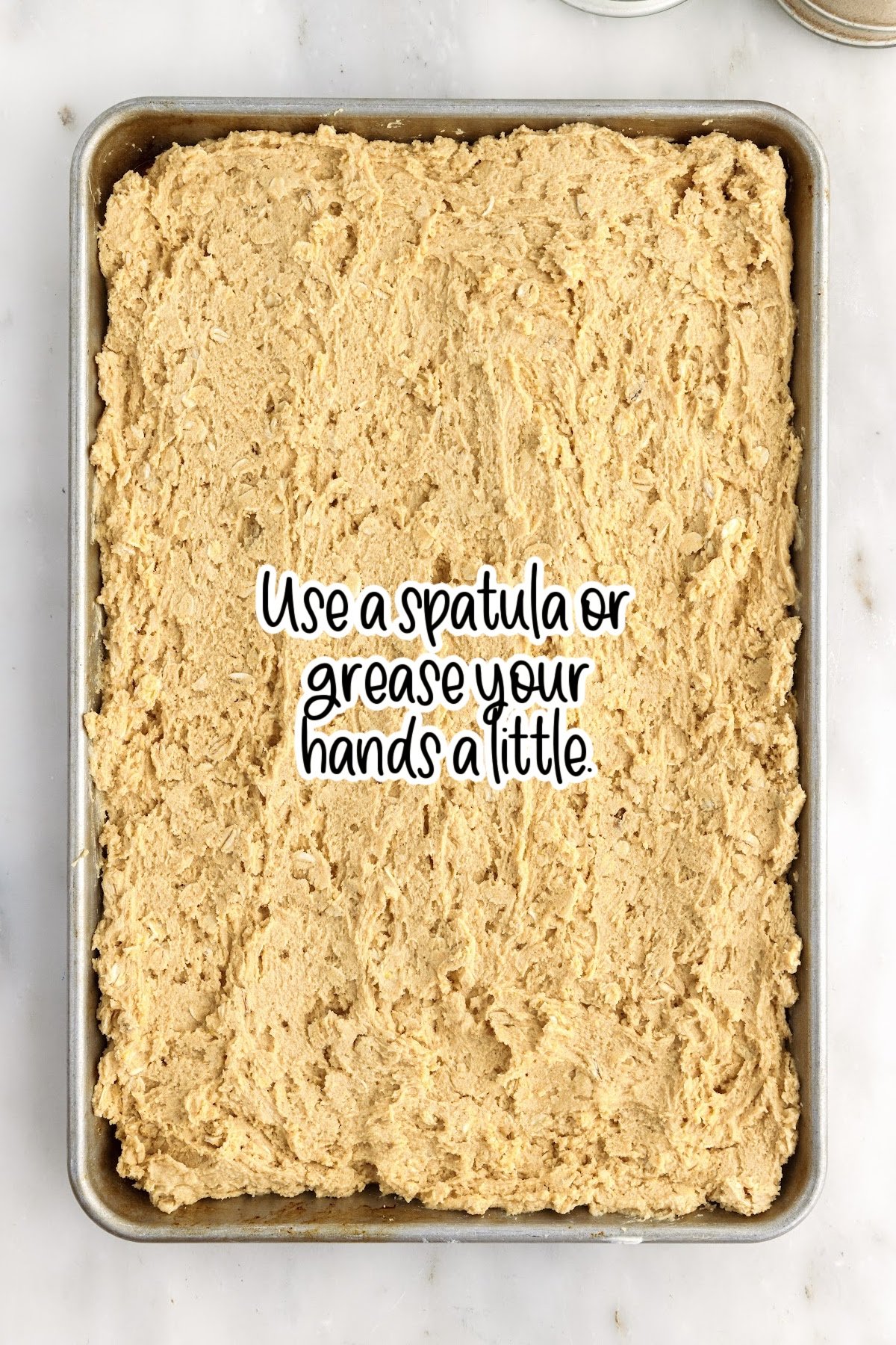 Lunch Lady Peanut Butter Bar batter in a 9x13 with text overlay.