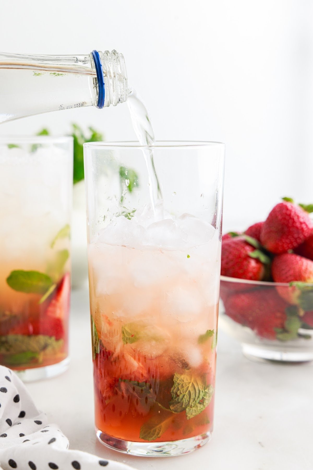 Sparkling water being added to the Strawberry Mojito.
