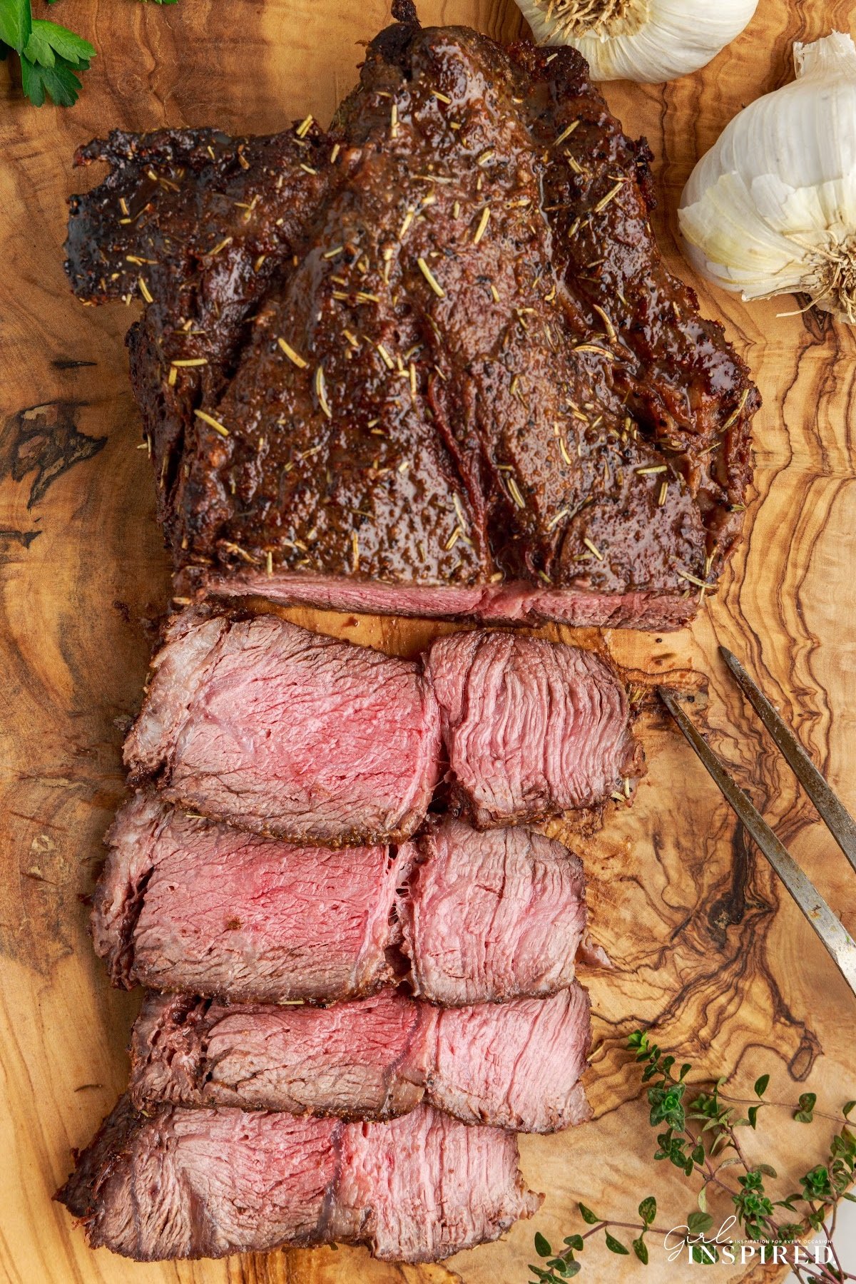 Overhead view of Air Fryer Roast Beef slices cut next to the whole roast.