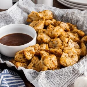 A basket of Air Fryer Chicken Bites next to sauce.