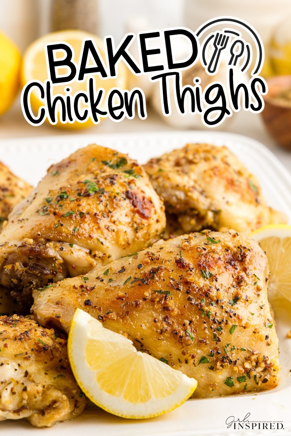 Baked Chicken Thighs on a platter with lemon slices with text overlay.