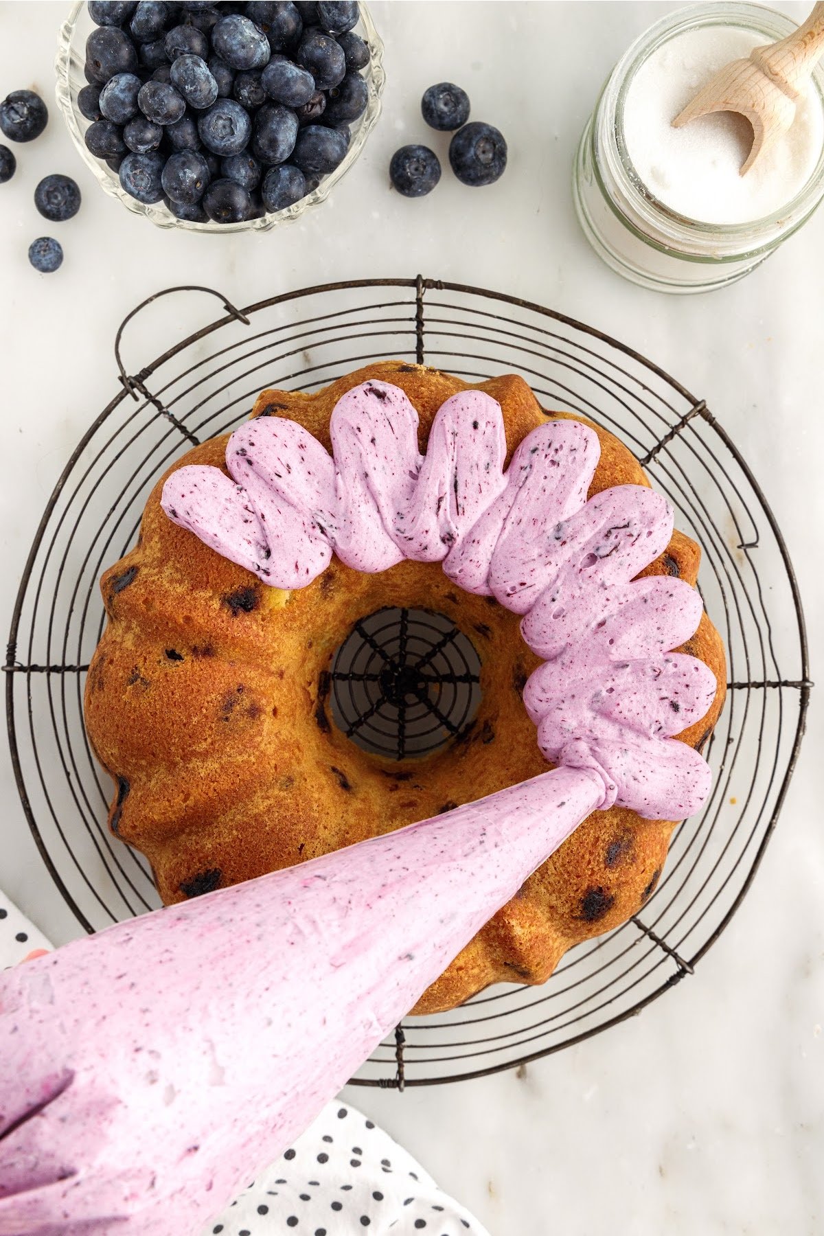 Blueberry Pound Cake piped with blueberry cream cheese frosting.