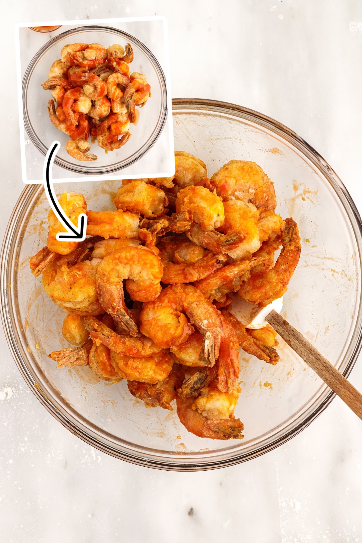 Two images of Buffalo Shrimp with buffalo sauce added to the top and Buffalo Shrimp after being mixed with buffalo sauce with a spatula inserted.