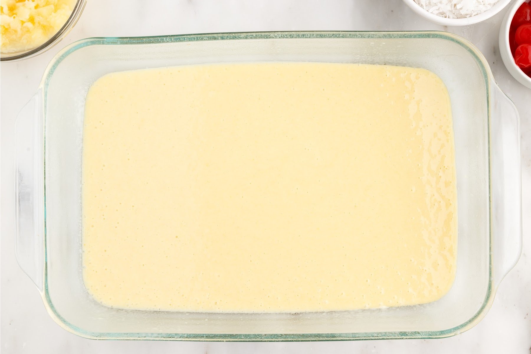 Millionaire’s Cake cake batter in a 9x13 glass dish.