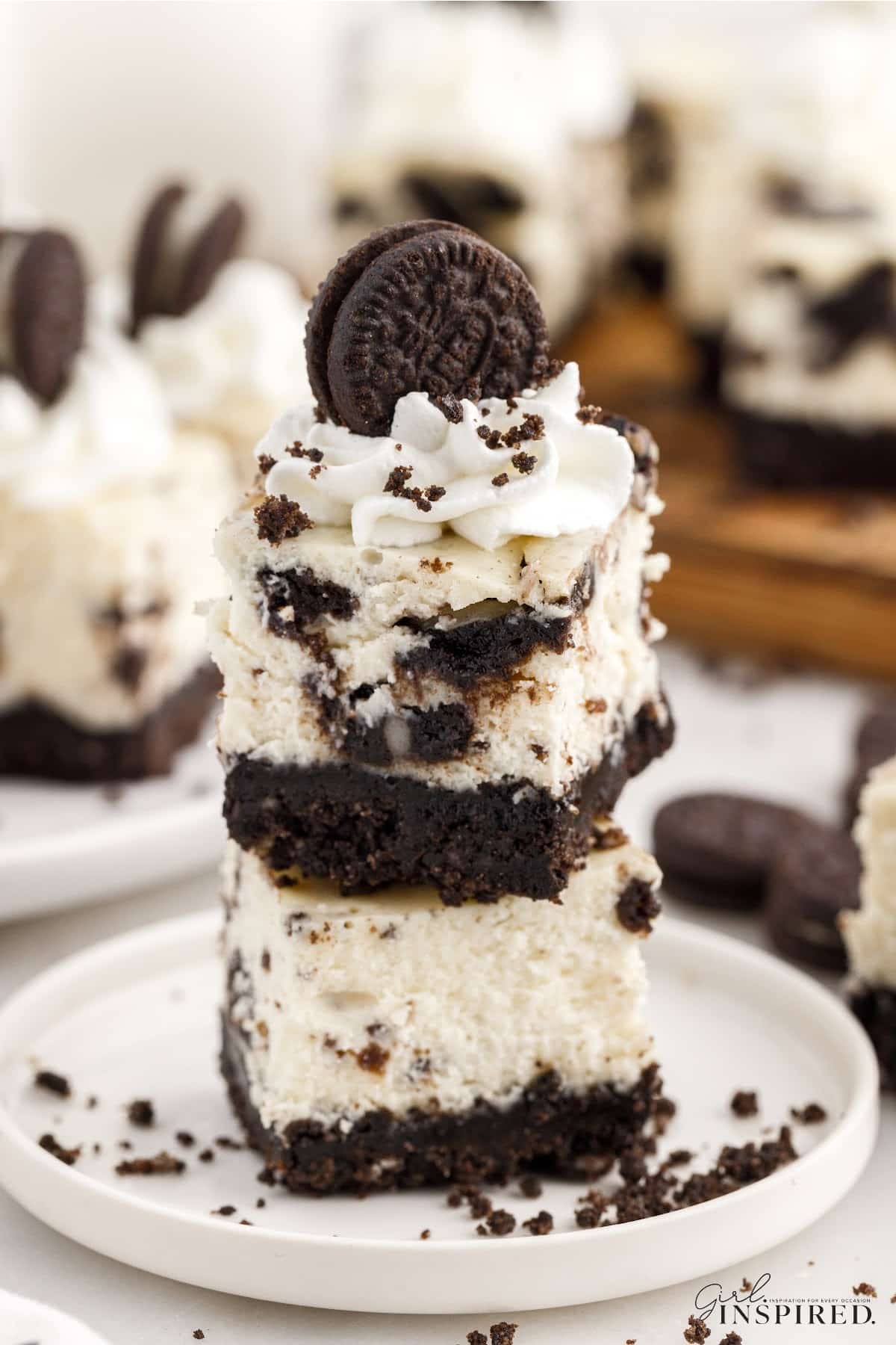 Two Oreo Cheesecake Bites stacked on each other and a mini oreo on the top.