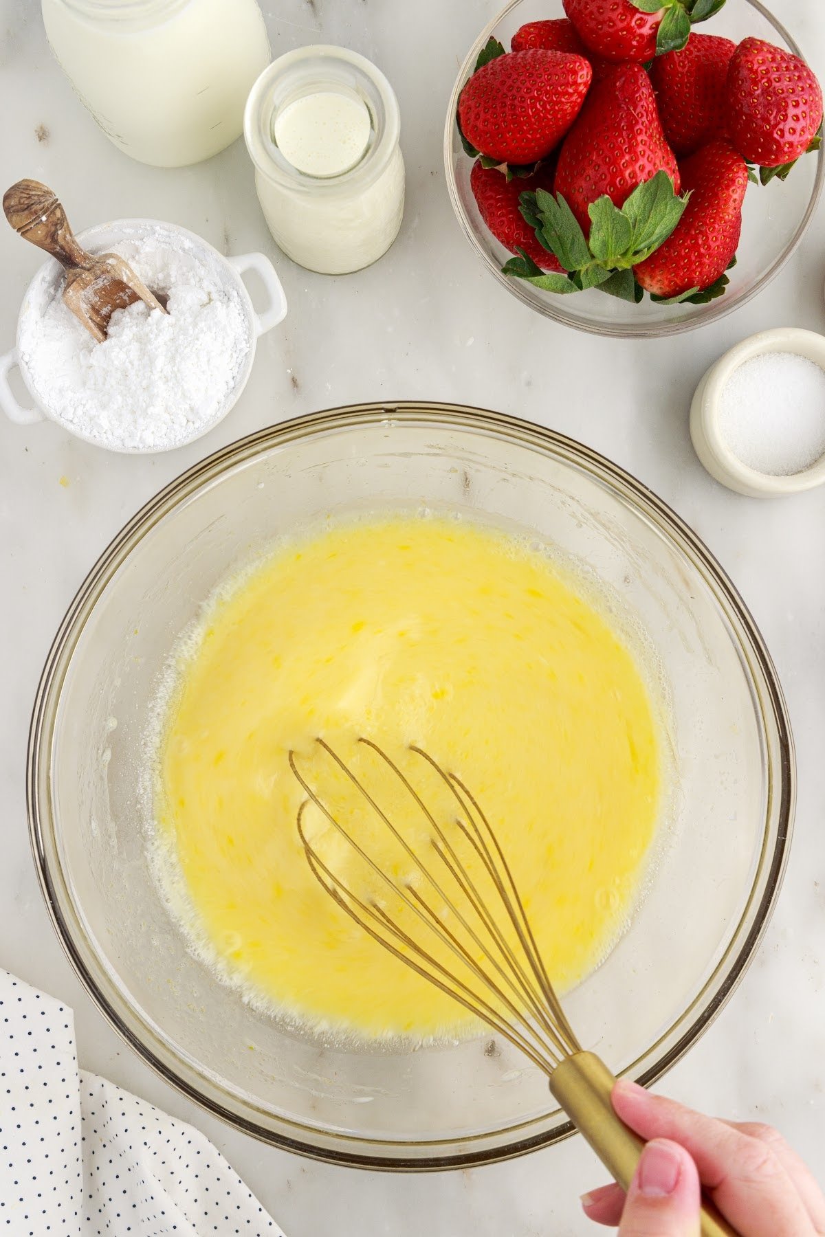 Sugar, buttermilk, vanilla, and eggs in a mixing bowl.