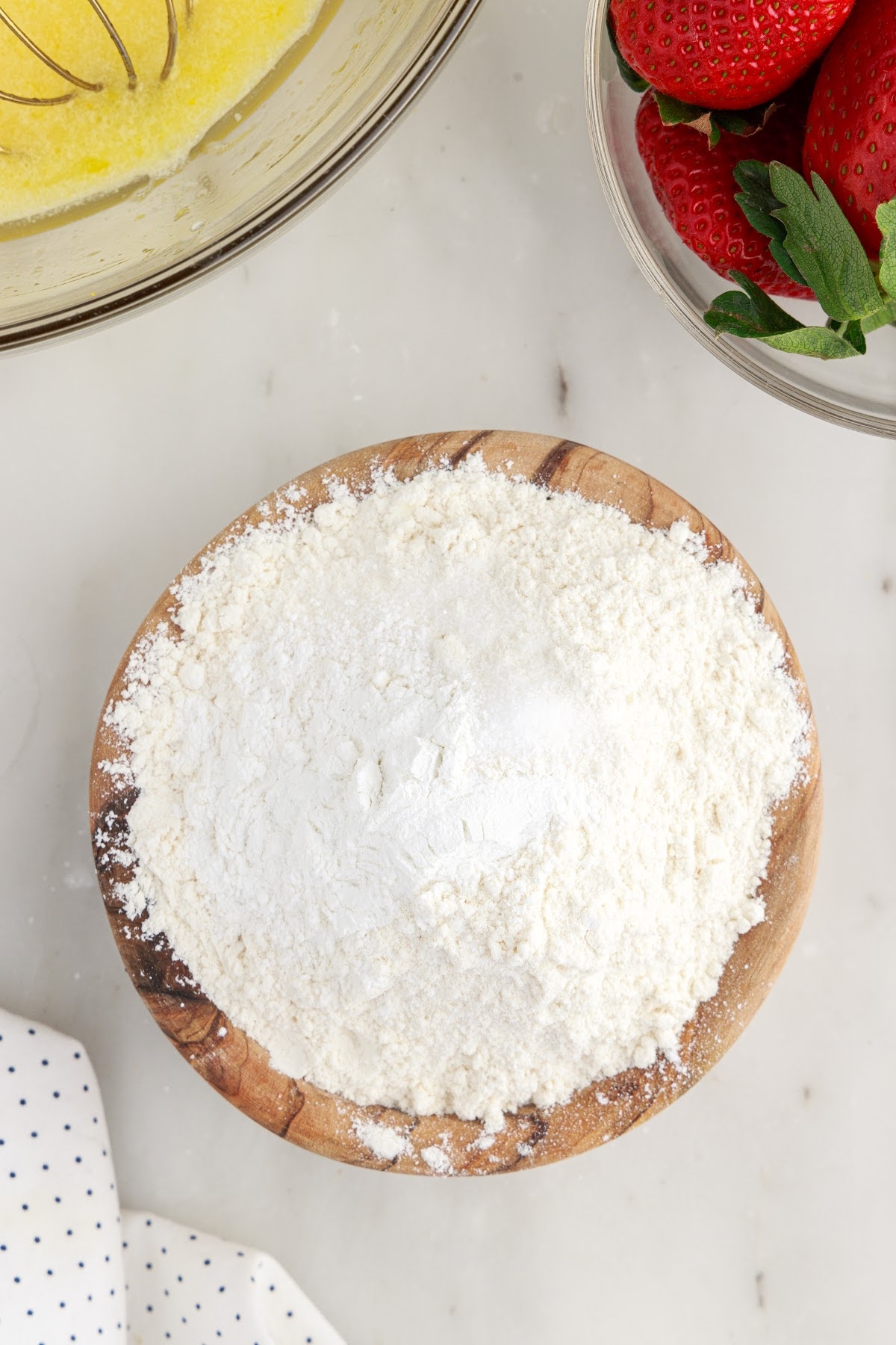 Flour, salt, baking soda, and baking powder in a bowl.