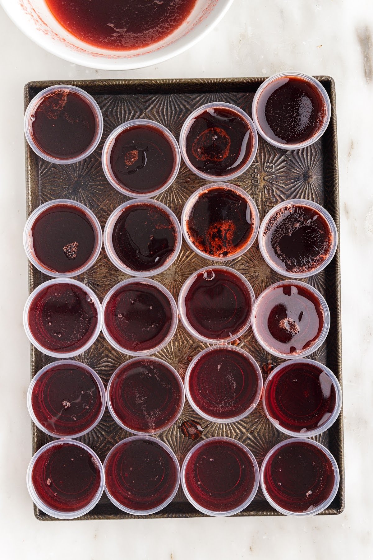 Overhead view of Cherry Coke Jello Shots on a cookie sheet.