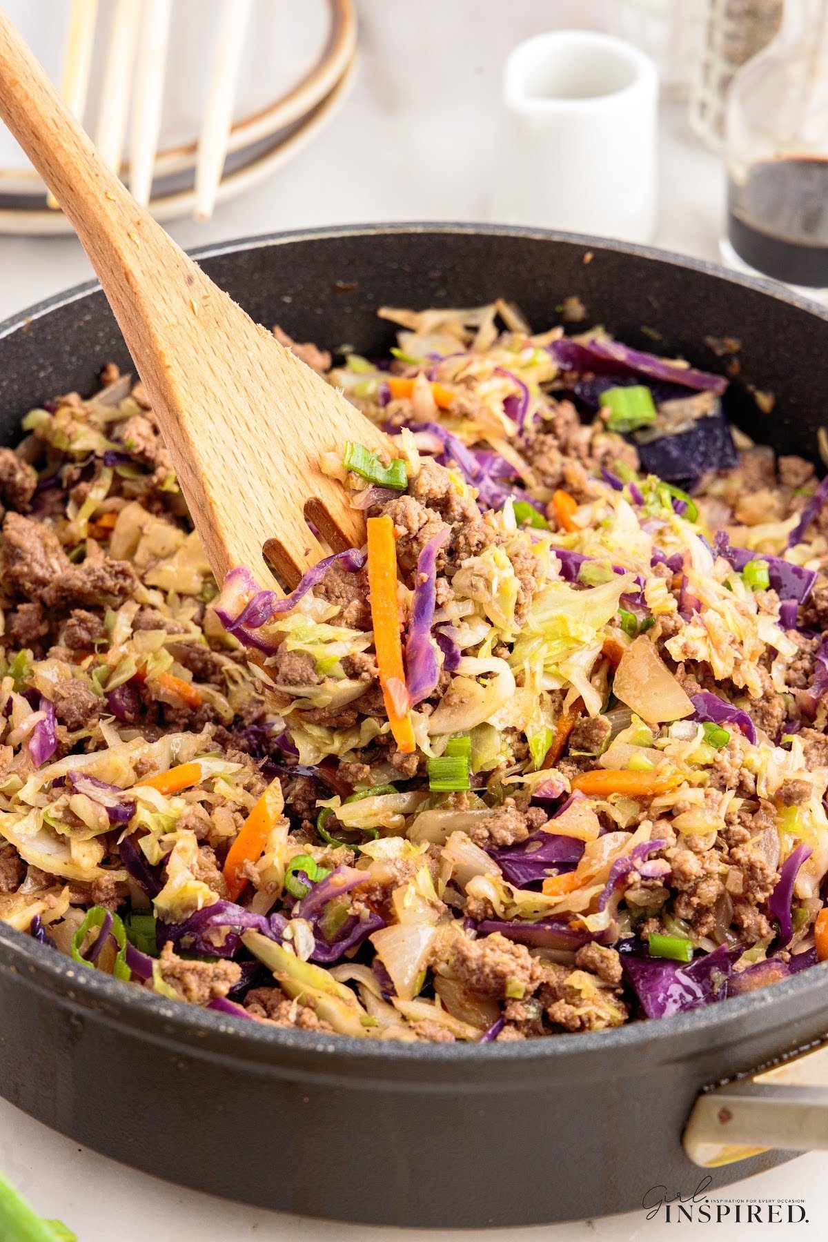 Crack Slaw in a skillet with a wooden spatula.
