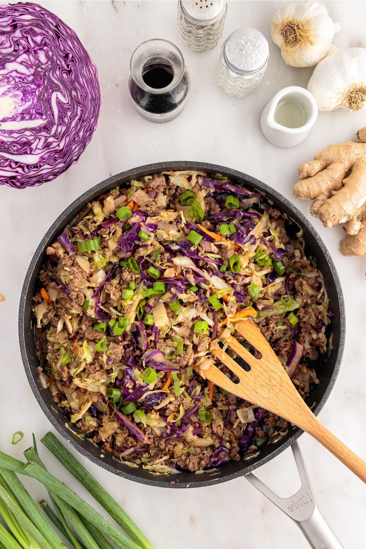 Overhead view of Crack Slaw in a skillet with a spatula.