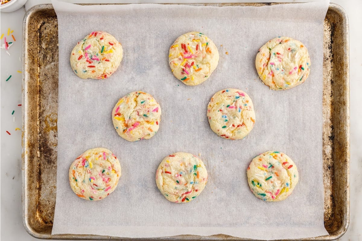 Confetti Cake Mix Cookies after being baked on a parchment paper lined cookie sheet.