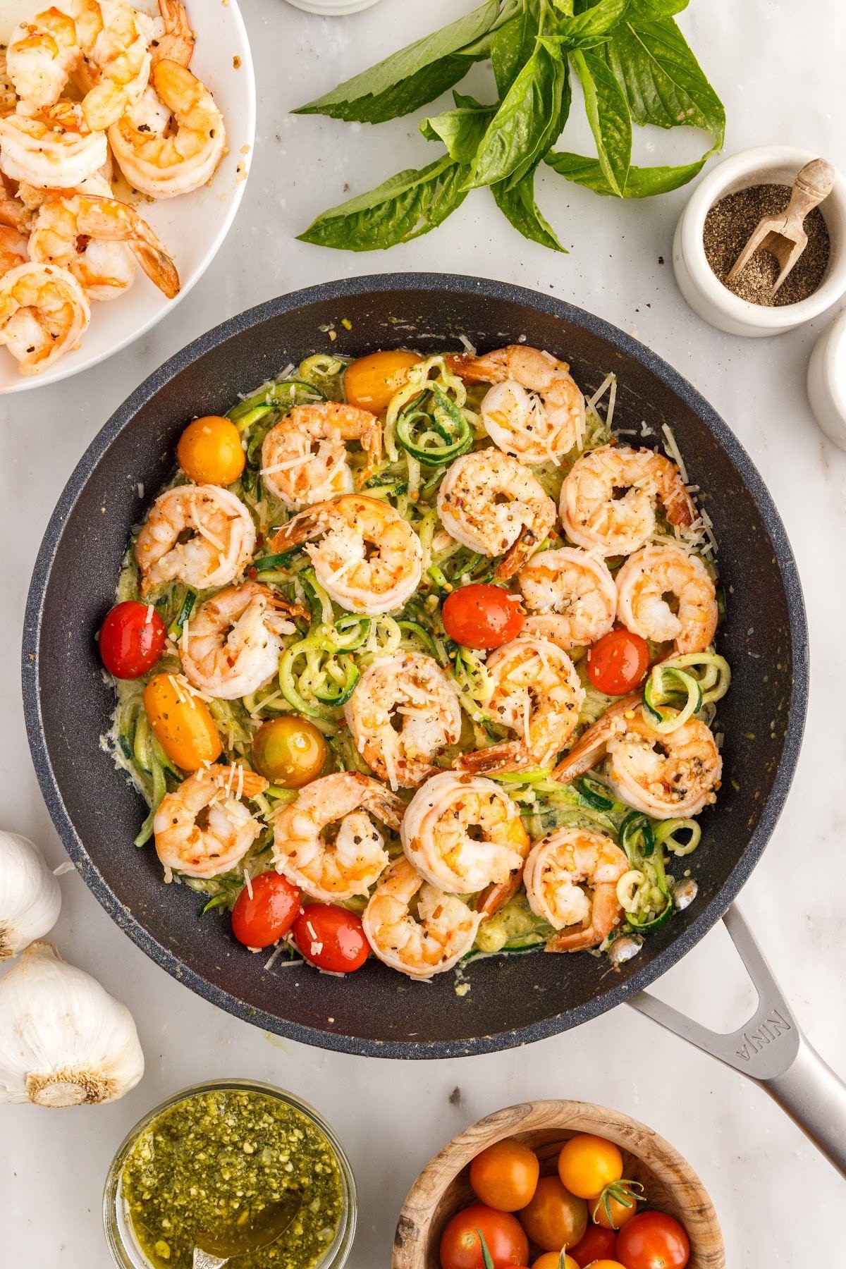 Pesto Zucchini Noodles with Shrimp in a skillet.