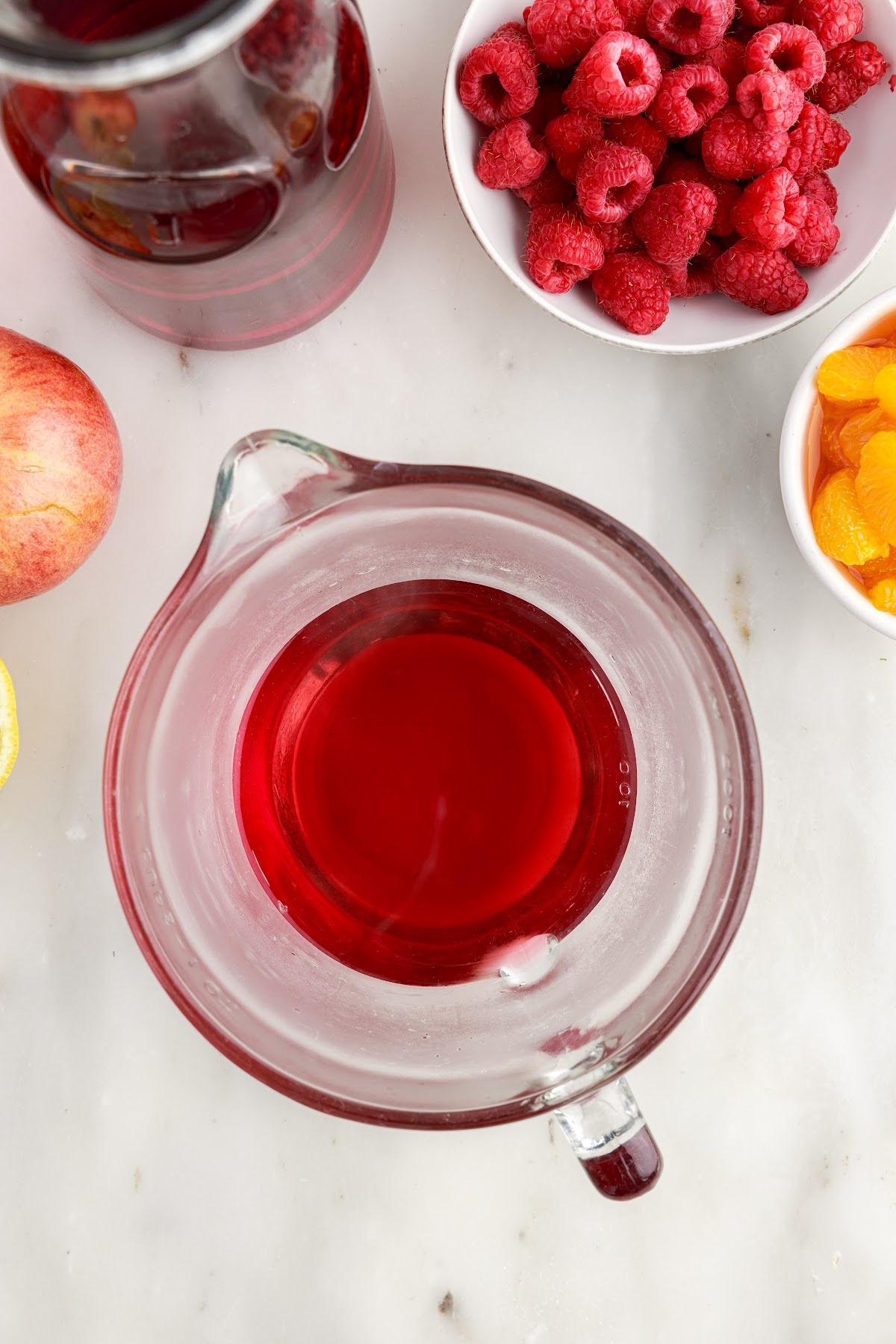 Cran raspberry juice in a measuring cup.