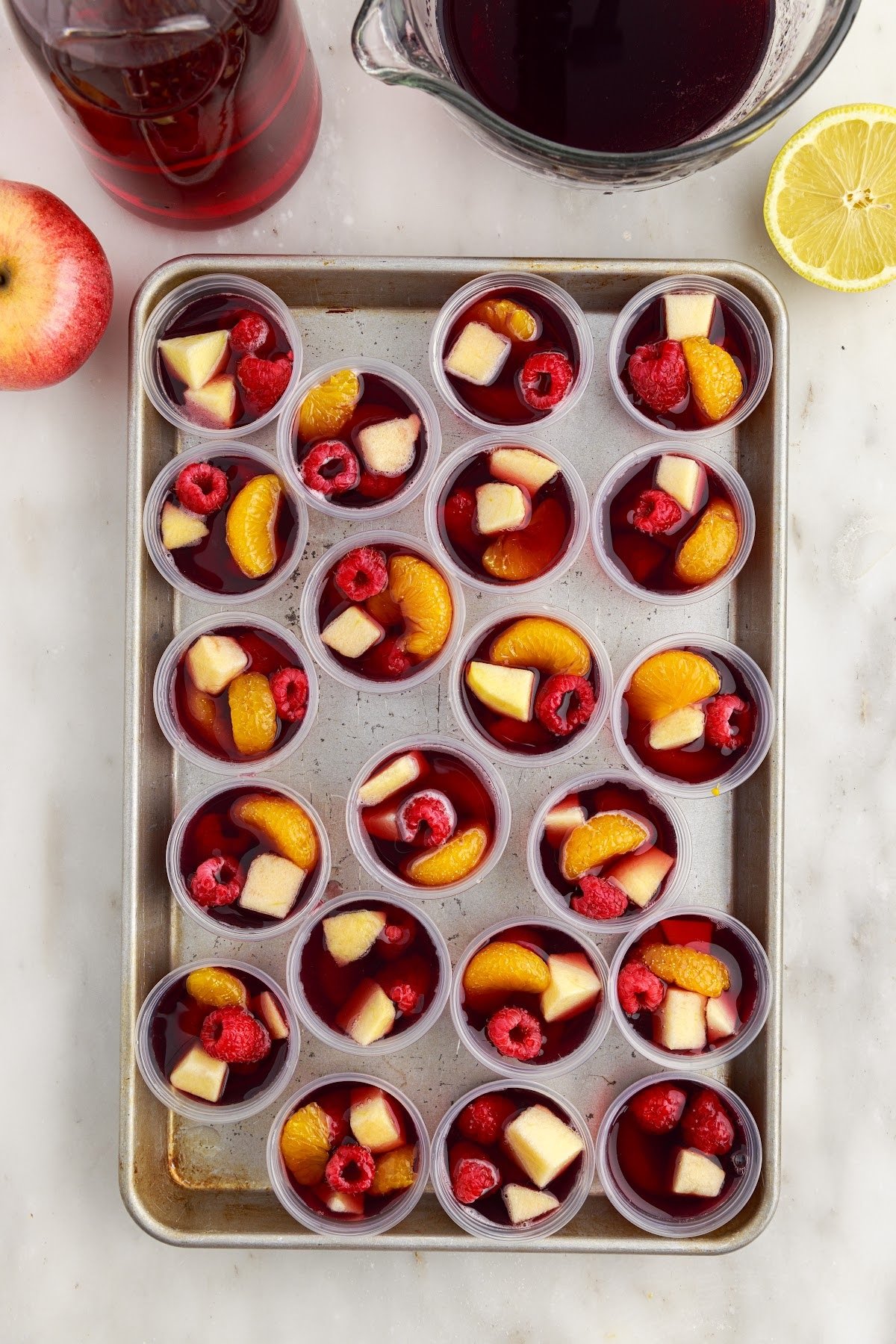 Sangria Jello Shots on a parchment paper lined cookie sheet.
