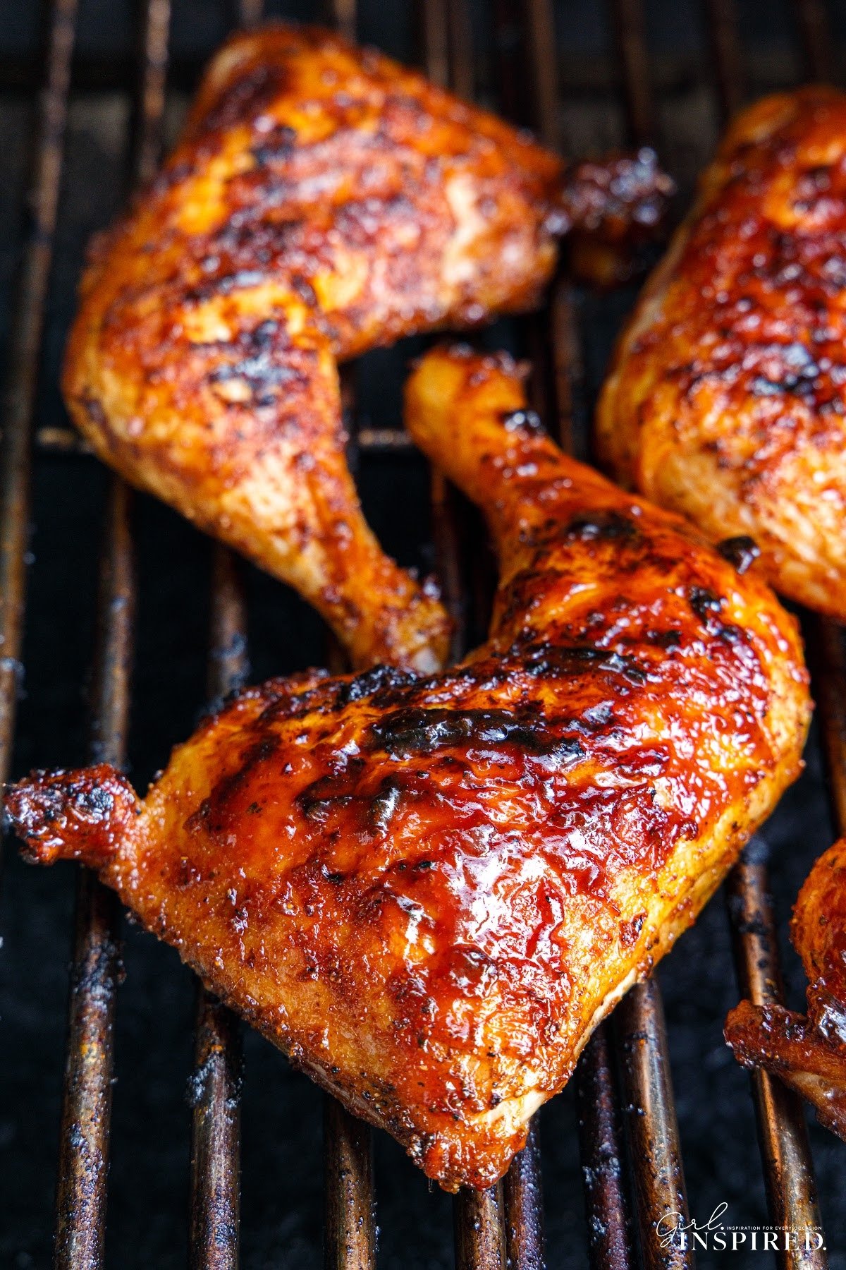 Close up of Smoked Chicken Leg Quarters on the grill.