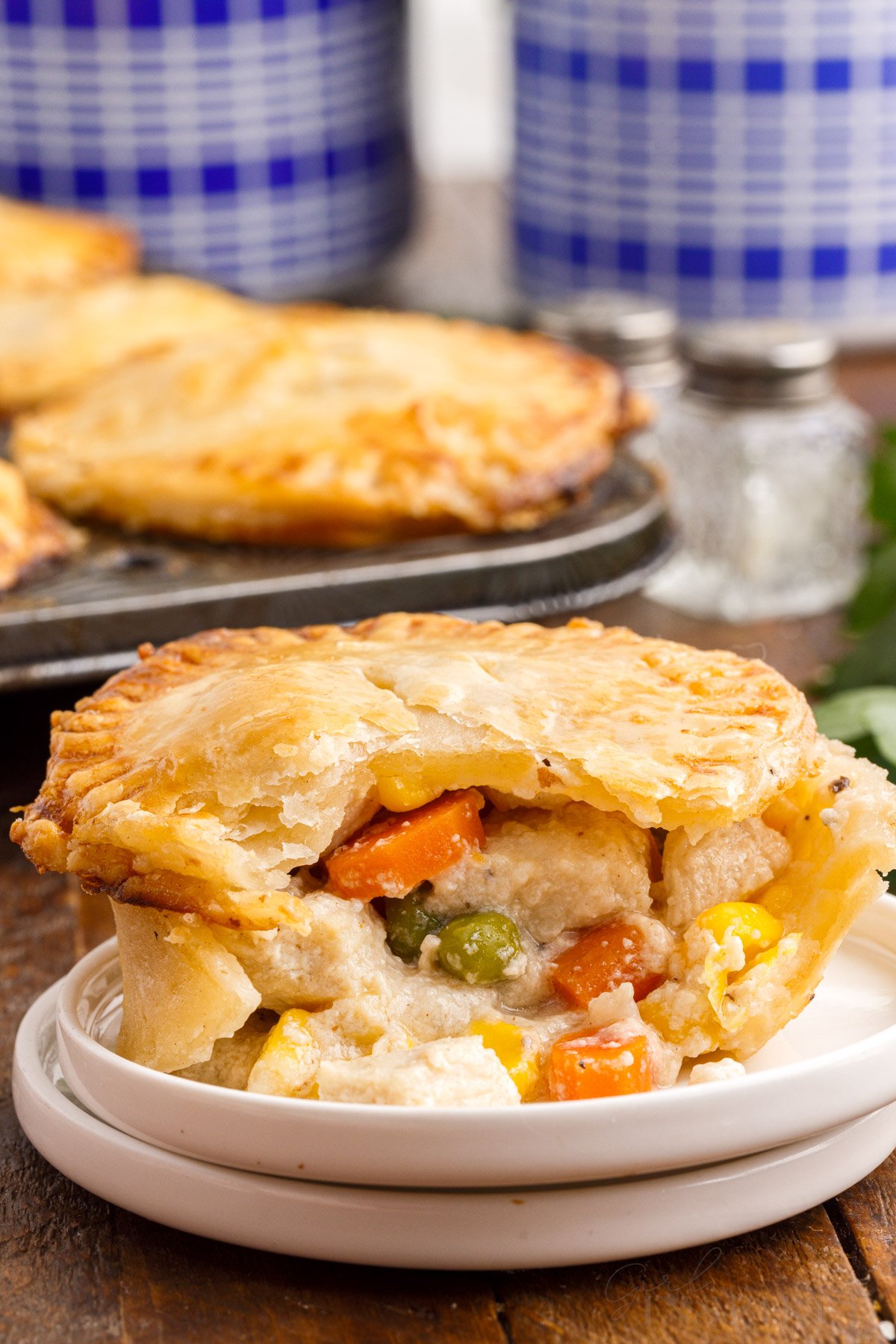 Front close up of a Mini Chicken Pot Pie on a plate cut open.