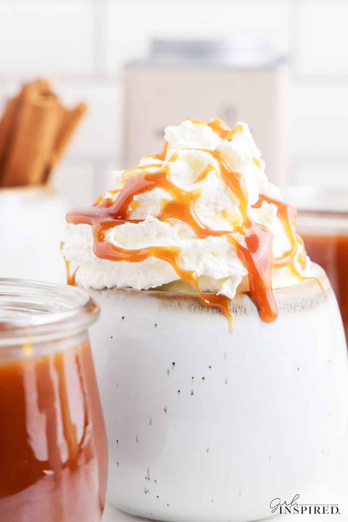 Close up of Starbucks Dark Caramel Sauce on whipped topping on a drink.