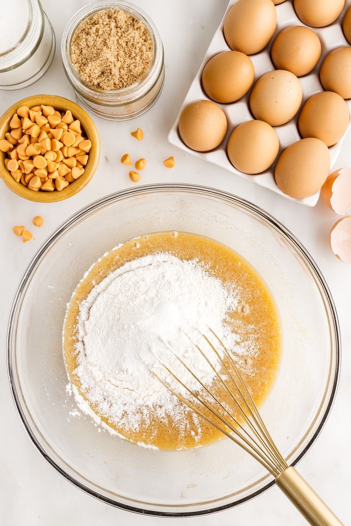 Salt, flour, and baking powder added to the mixture with a whisk.