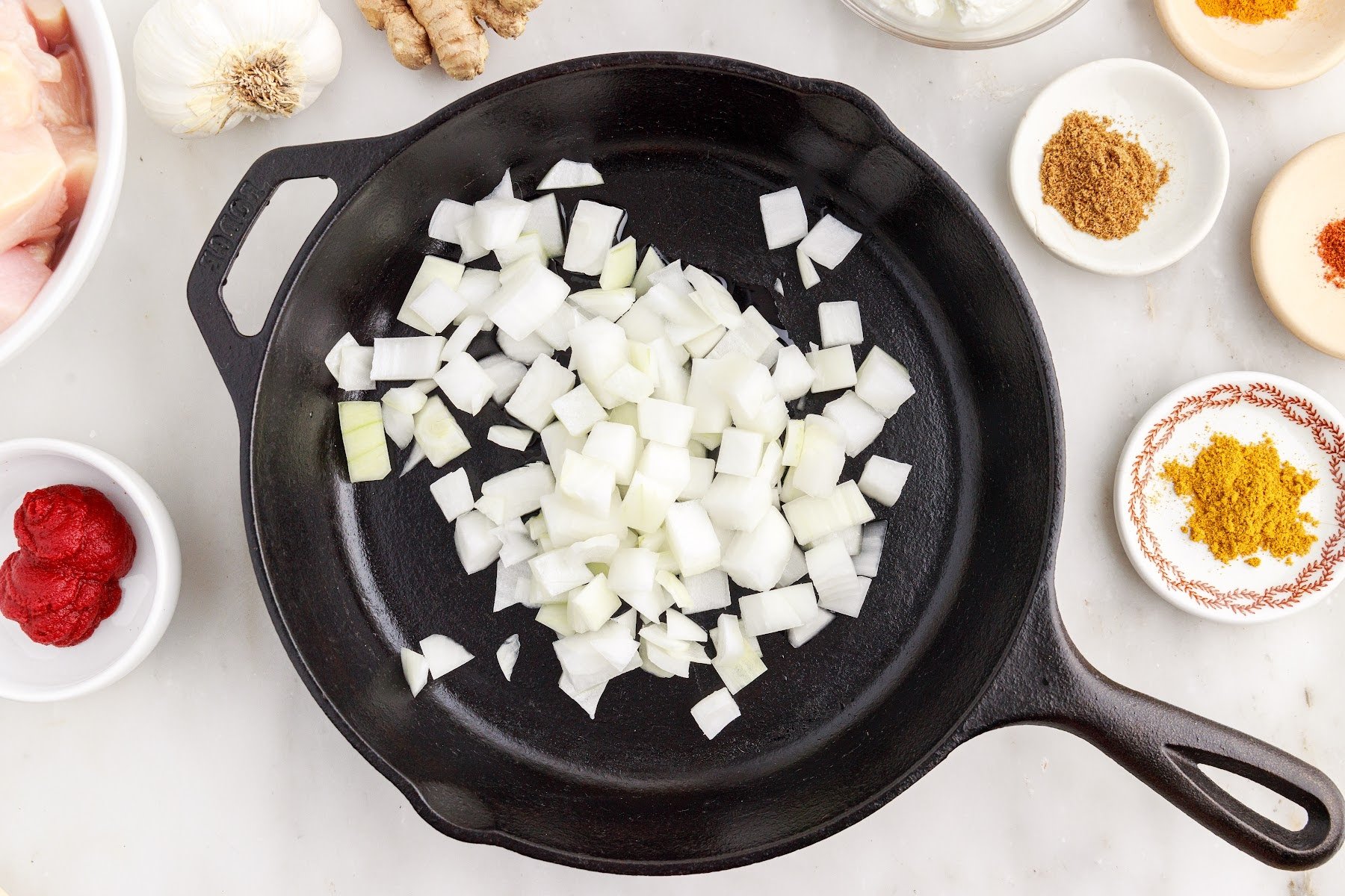 Onions added to a skillet.