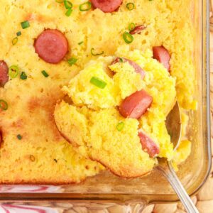 Overhead view of Corn Dog Casserole with a scoop being scooped.